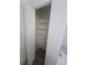 Linen closet with white shelves and bifold doors provides storage in the updated home at 383 Floral Dr, Winter Garden, FL 34787