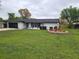 Charming single-story home with well-maintained lawn and landscaping details in front at 383 Floral Dr, Winter Garden, FL 34787