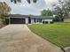 Charming single-story home with well-maintained lawn and extended driveway at 383 Floral Dr, Winter Garden, FL 34787