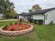 Well-maintained front yard featuring fresh landscaping and healthy green grass at 383 Floral Dr, Winter Garden, FL 34787