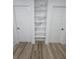 Hallway featuring built-in shelving with marble backsplash between two doors at 383 Floral Dr, Winter Garden, FL 34787
