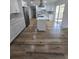 A modern kitchen with white cabinets, stainless steel appliances, a center island, and wood-look flooring at 383 Floral Dr, Winter Garden, FL 34787