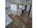 Open concept kitchen with island, wood flooring and stainless steel appliances at 383 Floral Dr, Winter Garden, FL 34787