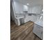 Modern kitchen with white cabinets, stainless steel appliances, and marble backsplash at 383 Floral Dr, Winter Garden, FL 34787