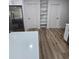 Bright kitchen with stainless steel appliances, marble shelving, and wood flooring at 383 Floral Dr, Winter Garden, FL 34787