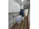 Updated laundry room with white cabinets, countertops, and new HVAC unit features wood-look floors at 383 Floral Dr, Winter Garden, FL 34787