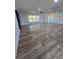 A spacious living room is shown featuring newly installed wood-look tile floors and lots of natural light at 383 Floral Dr, Winter Garden, FL 34787