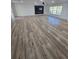 Spacious living room with wood-look flooring, a ceiling fan, and bright natural light from large windows at 383 Floral Dr, Winter Garden, FL 34787