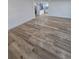 This is a view of the open-concept living room showcasing the wood-look flooring and modern kitchen beyond at 383 Floral Dr, Winter Garden, FL 34787