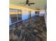 This patio has a tile floor, multiple ceiling fans, and sliding glass doors leading to the inside of the house at 383 Floral Dr, Winter Garden, FL 34787