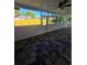 The screened-in porch features a ceiling fan and dark tile flooring and overlooks the fenced backyard at 383 Floral Dr, Winter Garden, FL 34787