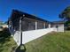 A white screened patio with black trim and modern design, offering a serene outdoor space at 383 Floral Dr, Winter Garden, FL 34787