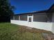 White enclosed patio, featuring a door to the backyard with a nice grassy yard, allowing indoor-outdoor living at 383 Floral Dr, Winter Garden, FL 34787