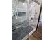 Modern shower featuring marble tile surround, built-in niche, and hexagon tile base at 383 Floral Dr, Winter Garden, FL 34787