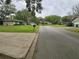 Peaceful street view showcasing a well-manicured lawn and friendly neighborhood at 383 Floral Dr, Winter Garden, FL 34787