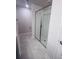 A bathroom features a bright, tiled shower stall enclosed with sleek glass doors at 4236 Sagefield Dr., St Cloud, FL 34773