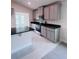 Spacious kitchen with stainless steel appliances, granite countertops, gray cabinets, and large island at 4236 Sagefield Dr., St Cloud, FL 34773