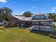 Expansive backyard features a screened pool, porch swing, pergola covered patio, and a manicured lawn at 4240 Lake Harney Cir, Geneva, FL 32732