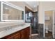Modern bathroom with double sinks, large mirror, and a glass-enclosed shower at 4240 Lake Harney Cir, Geneva, FL 32732