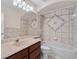 Bathroom featuring decorative tile shower and dark cabinets at 4240 Lake Harney Cir, Geneva, FL 32732