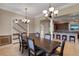 Spacious dining room with an exquisite table, chandelier, and seamless flow to the open kitchen and staircase at 4240 Lake Harney Cir, Geneva, FL 32732