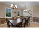 Elegant dining room with a spacious table, chandelier lighting, and large windows for natural light at 4240 Lake Harney Cir, Geneva, FL 32732