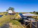 Charming stilt home with deck next to a boat dock and lift on the waterway, perfect for boating enthusiasts at 4240 Lake Harney Cir, Geneva, FL 32732
