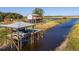 Elevated home near boat dock with lift, nestled on a canal; an idyllic setting for waterside living and recreation at 4240 Lake Harney Cir, Geneva, FL 32732