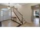 Bright foyer with tile flooring, a staircase with white railing, and ample natural light from the front door at 4240 Lake Harney Cir, Geneva, FL 32732