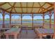 Cozy gazebo featuring tables with a scenic view overlooking the water at 4240 Lake Harney Cir, Geneva, FL 32732