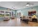 Inviting living room with neutral tones, tile flooring, and French doors that lead to the backyard at 4240 Lake Harney Cir, Geneva, FL 32732