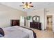 Bright bedroom showcasing tile floors, a ceiling fan, and access to an ensuite bathroom at 4240 Lake Harney Cir, Geneva, FL 32732