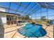 Backyard pool with a screened enclosure, outdoor kitchen, and waterfront views at 4240 Lake Harney Cir, Geneva, FL 32732