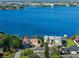 An aerial view capturing the serene lake, the homes along the shore, and the property at 4321 Summer Ln, Orlando, FL 32804
