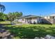 Large backyard with grass, mature trees and an outdoor seating area at 4321 Summer Ln, Orlando, FL 32804
