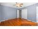 Spacious bedroom featuring hardwood floors, ceiling fan and ample closet space at 4321 Summer Ln, Orlando, FL 32804