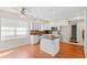 Well-lit kitchen featuring a center island, white cabinets, and hardwood floors next to a large window at 4321 Summer Ln, Orlando, FL 32804