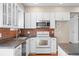 Bright kitchen featuring stainless steel appliances, ample cabinet space, and laminate countertops next to a pantry closet at 4321 Summer Ln, Orlando, FL 32804