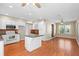 Open kitchen with stainless steel appliances, tile backsplash, white cabinetry, and an island with additional seating at 4321 Summer Ln, Orlando, FL 32804