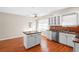 Bright kitchen featuring white cabinets, stainless steel appliances and central island with butcher block countertop at 4321 Summer Ln, Orlando, FL 32804