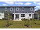 A backyard view with a screened-in patio, small trees, and a well-kept lawn at 4839 Jackstaff Way, Oviedo, FL 32765