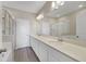 This bathroom offers double sinks, a wide mirror, tile floors, and a glass-enclosed shower at 4839 Jackstaff Way, Oviedo, FL 32765