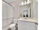 Bathroom with a white vanity, mirror, shower/tub combo, and neutral decor at 4839 Jackstaff Way, Oviedo, FL 32765