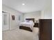 Cozy bedroom with neutral walls, carpet, wooden furniture, and a queen bed with lilac bedding at 4839 Jackstaff Way, Oviedo, FL 32765