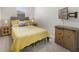 This bedroom features a queen bed with a bright yellow bedspread, a mounted TV, and carpeted floors at 4839 Jackstaff Way, Oviedo, FL 32765