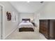 Cozy bedroom with neutral walls, carpet, wooden furniture, and a queen bed with lilac bedding at 4839 Jackstaff Way, Oviedo, FL 32765