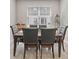 Formal dining room with a wooden table, six chairs, and a large window at 4839 Jackstaff Way, Oviedo, FL 32765