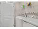 Neat laundry room with modern appliances, a wire rack, and a door at 4839 Jackstaff Way, Oviedo, FL 32765