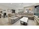 Bright, open-concept living room featuring a large sofa, tile floors, and modern accents at 4839 Jackstaff Way, Oviedo, FL 32765