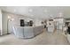Bright, open-concept living room with tile floors that flows into a modern kitchen area at 4839 Jackstaff Way, Oviedo, FL 32765